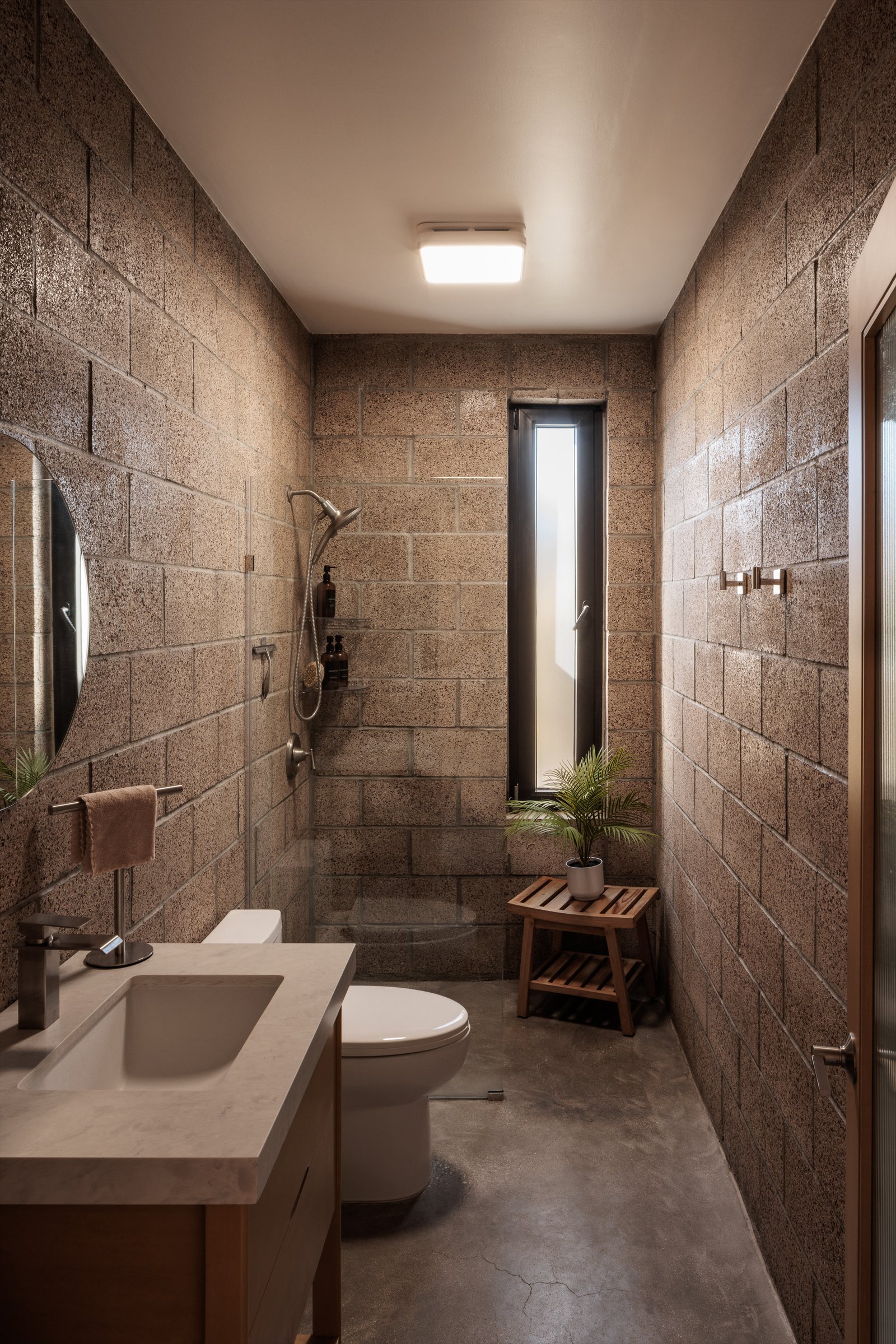 ADU Completed - Bathroom with walk-in shower and cinder block walls