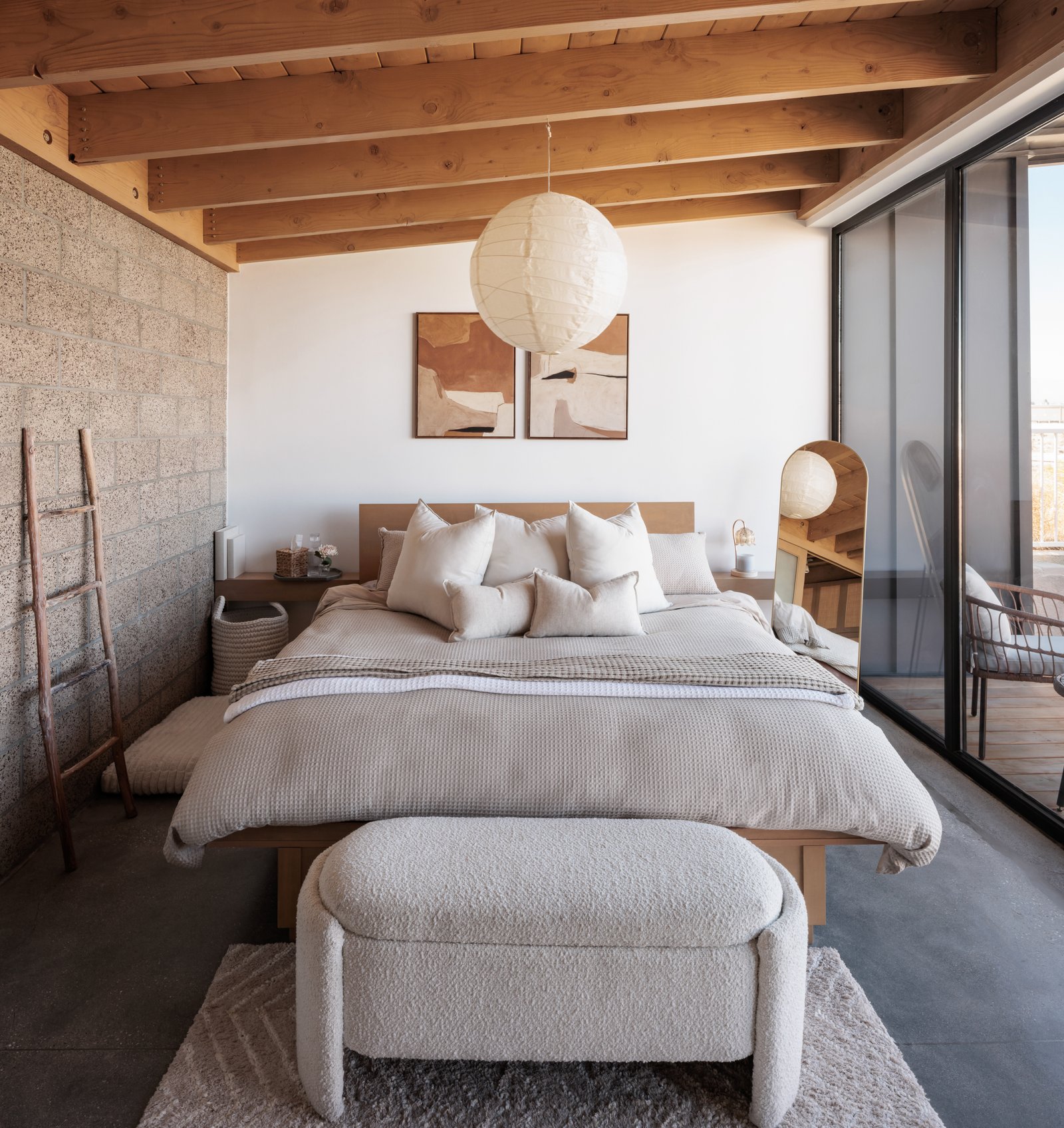 ADU Completed - Bedroom with boucle bench and cinder block accent wall